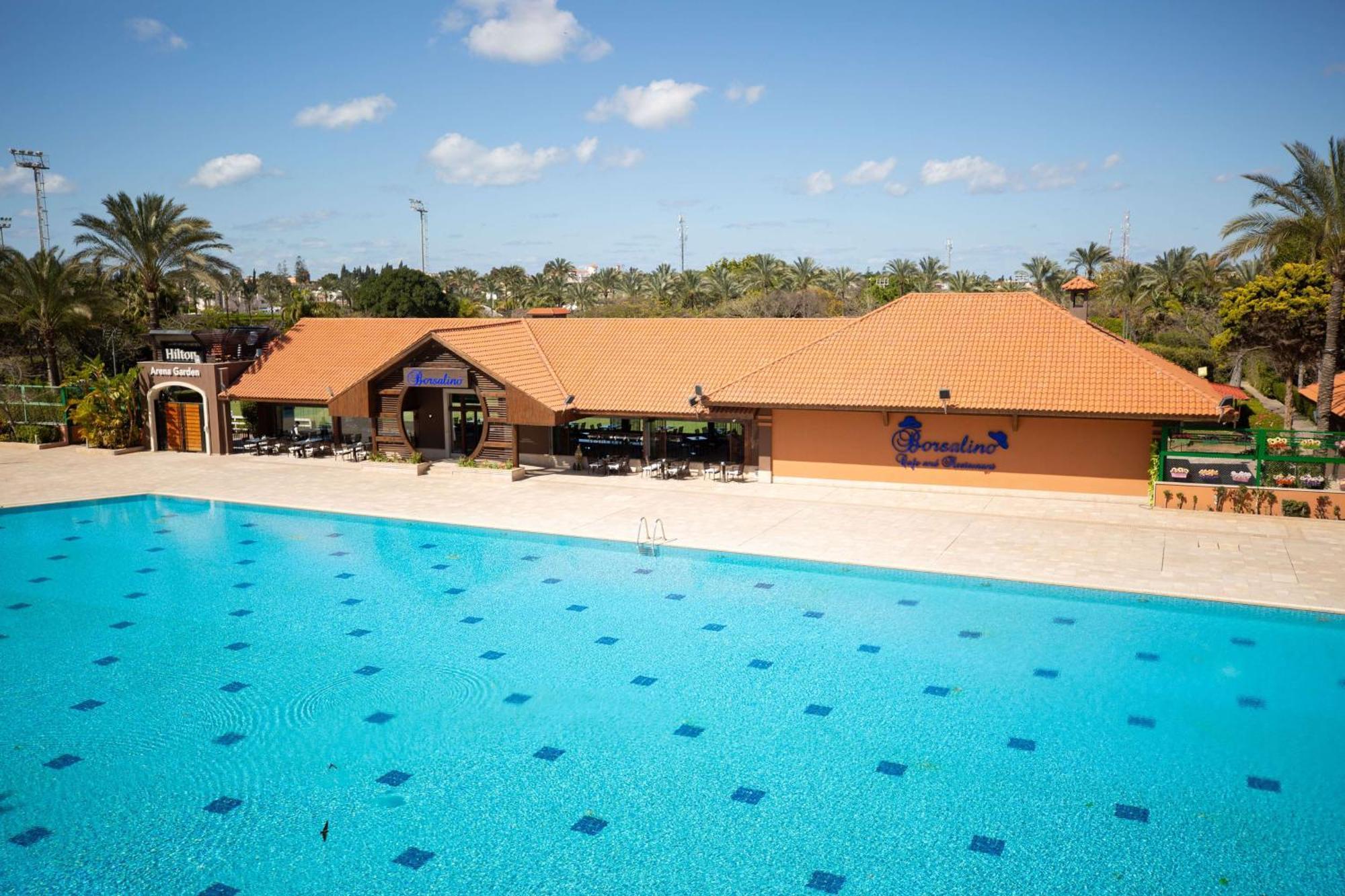 Hilton Alexandria King'S Ranch Hotel King Mariout Exterior foto Swimming pool at the kibbutz